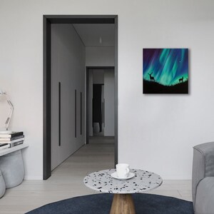 May include: A painting of a green and blue aurora borealis with two deer silhouettes in the foreground.