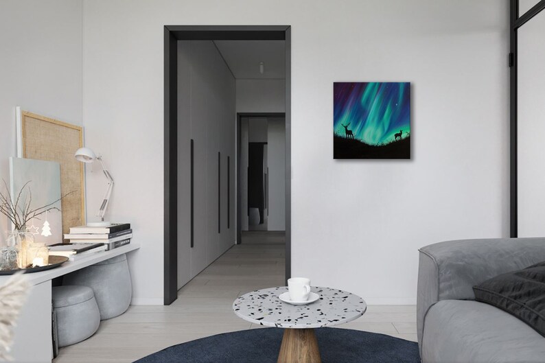 May include: A painting of a green and blue aurora borealis with two deer silhouettes in the foreground.