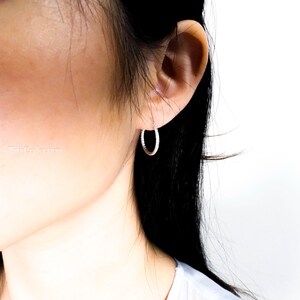 Model wearing shiny textured hoop earrings everyday style