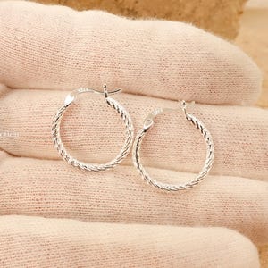 Shiny wavy texture sterling silver thin hoops detail
