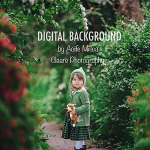 以下が含まれることがあります： 緑のセーターと格子柄のスカートを着た若い女の子が、緑豊かな緑の庭の道に立っています。彼女はぬいぐるみのおもちゃのキツネを持っており、緑の帽子をかぶっています。画像には「DIGITAL BACKGROUND by Aoife Millea Cleare Photography」というテキストが重ねられています。