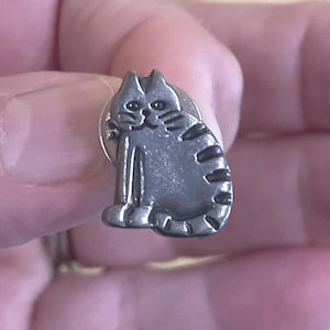 May include: A set of three ceramic mugs with a speckled, matte finish. The mugs are in shades of cream, light gray, and dark gray. Each mug has a simple, minimalist design, perfect for coffee or tea.