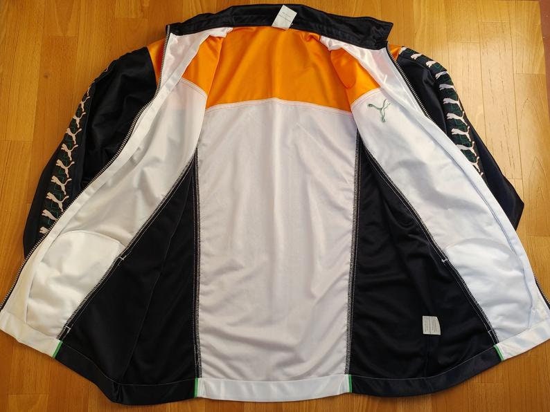 orange and black puma jacket