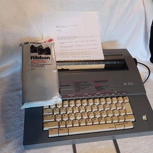 Smith-Corona electric typewriter SL 470 new ribbon and correcting tape and 2 extra ribbons