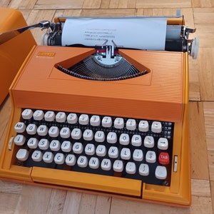 Orange  Sears Chevron portable typewriter,  new ribbon