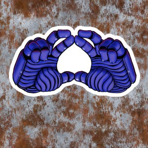 May include: A sticker featuring two blue robotic hands with segmented fingers and armored plating, positioned to form a heart shape. The hands are rendered in a vibrant blue with dark outlines and shading, set against a white border outline.