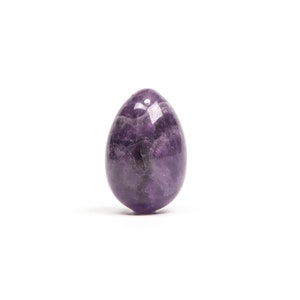 May include: A smooth, purple amethyst egg-shaped crystal.