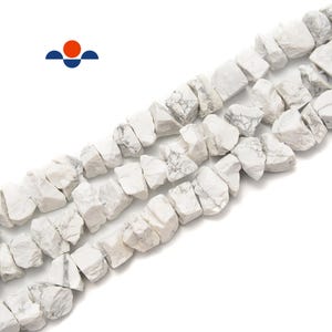 May include: Strands of white and gray Howlite gemstone beads. The beads have a rough, irregular shape, and are strung together. The beads are a neutral color, and would be suitable for jewelry making.