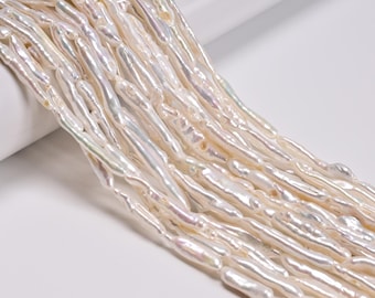 May include: A strand of elongated, irregular white freshwater pearls with a high-luster, iridescent finish. The pearls are shaped like long, slender sticks or tubes, arranged in a parallel formation to showcase their natural, textured surfaces.