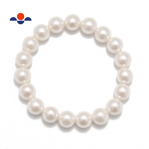 May include: A white pearl bracelet, circular in shape, against a white background. The pearls are round and evenly sized. The bracelet is a classic piece of jewelry.