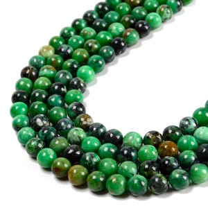 May include: Strands of green gemstone beads in various shades, including bright, dark, and mottled green. The beads are round and smooth, with a polished finish. The beads are strung together, creating a necklace or bracelet.