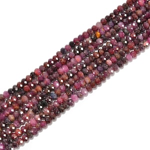 May include: Strands of faceted gemstone beads in shades of red, pink, and burgundy. The beads are small and round, with a sparkling, polished finish. The gemstones are strung together, creating a beautiful and colorful display.
