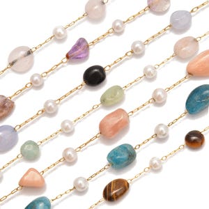 May include: Close-up of several strands of necklaces with gold chains, featuring a variety of colorful gemstones and white pearls. The gemstones include pink, purple, green, black, and blue stones. The pearls are small and round.