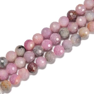 May include: Strands of faceted, round gemstones in shades of pink, lavender, and gray. The beads have a polished, reflective surface and are strung together, suitable for jewelry making. The gemstones vary in color and have a subtle sparkle.