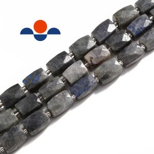 May include: Strands of faceted labradorite beads in shades of gray, blue, and black. The rectangular beads are strung together with silver-colored metal spacers. The gemstones have a polished, reflective surface. The image is of a jewelry component.