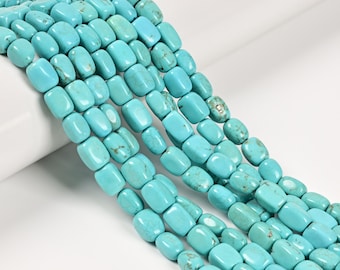 May include: Close-up of strands of turquoise beads. The beads are a light blue color with natural variations and a polished finish. The beads are rectangular and slightly rounded, strung together to create a necklace or bracelet.