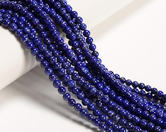 May include: Strands of deep blue, round gemstone beads. The beads have a polished, reflective surface and are strung together, creating a flowing, textured appearance. The beads are a rich, dark blue color, with subtle variations in tone.