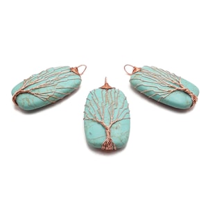 May include: Three turquoise pendants with copper wire tree designs. The pendants are rectangular and feature a light blue-green stone. The copper wire is wrapped around the stone in a tree-like pattern, with a loop at the top for hanging.