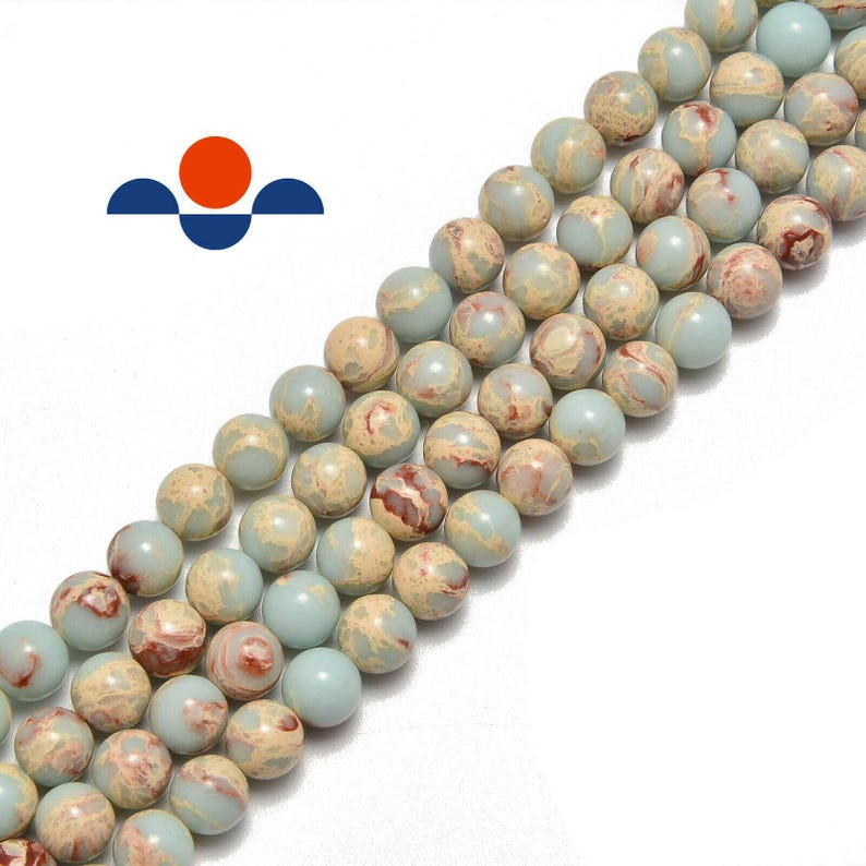 May include: Strands of round, polished beads in shades of pale blue, tan, and reddish-brown. The beads have a marbled appearance, suggesting natural stone. These beads are suitable for jewelry making, such as necklaces and bracelets.