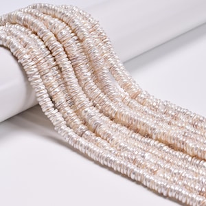 May include: A collection of multiple strands of white, coin-shaped freshwater pearls. Each pearl features a flattened, circular profile with a natural, iridescent luster and a slightly irregular, organic texture, arranged in parallel rows.