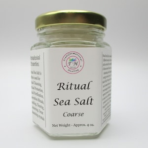 May include: A glass jar with a gold lid filled with coarse sea salt. The label reads "Ritual Sea Salt Coarse" and "Net Weight - Approx. 4 oz."