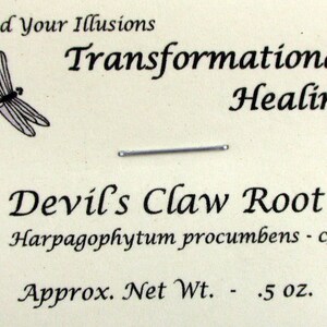 May include: A small bag of Devil's Claw Root, Harpagophytum procumbens, with a dragonfly illustration and the text "Shed Your Illusions Transformational Healing" on a white background. The bag contains 0.5 ounces of the herb.