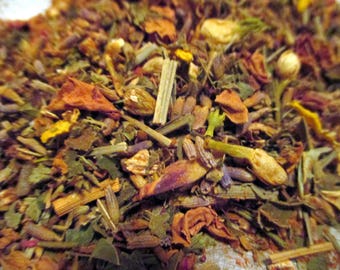 May include: A close-up of a blend of dried herbs and flowers, including lavender, rose petals, and other botanicals. The mixture is a variety of colors, including purple, pink, orange, and green.