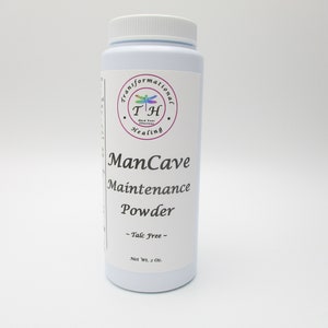 May include: White plastic bottle with a label that reads "ManCave Maintenance Powder - Talc Free - Net Wt. 2 Oz.". The label also features a logo with a dragonfly and the text "Transformational T+H Healing".