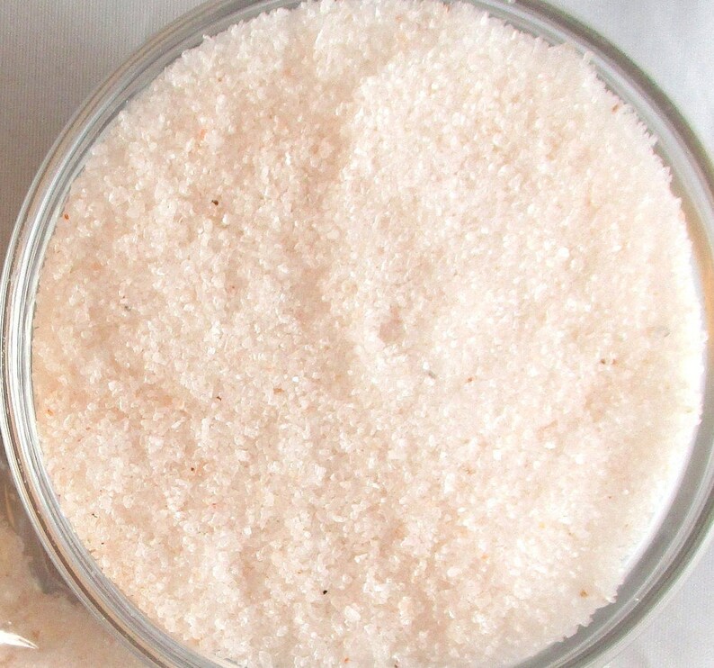 May include: Close-up view of fine-grained pink Himalayan salt in a clear glass jar.