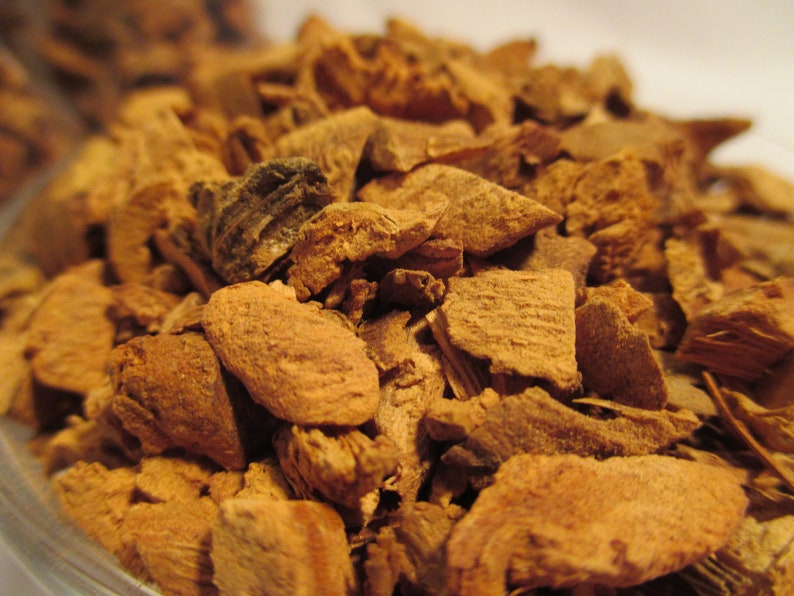May include: Close-up of a pile of dried, brown, and slightly reddish bark pieces. The bark is broken into irregular shapes and sizes.