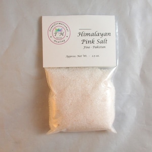 May include: A small white bag with a label that reads "Himalayan Pink Salt Fine - Pakistan Approx. Net Wt. - 2.5 oz." The bag contains fine pink Himalayan salt.