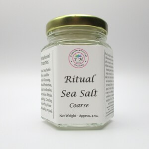 May include: A glass jar with a gold lid filled with coarse sea salt. The label reads "Ritual Sea Salt Coarse" and "Net Weight - Approx. 4 oz."