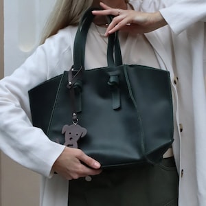 Dark green Purse made of matte genuine leather, can be supplied with a shoulder strap or a makeup bag, also two types of clasp on top