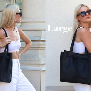 May include: A large black leather tote bag with a bow detail. The bag is shown in two sizes, with the larger size labeled "Large".