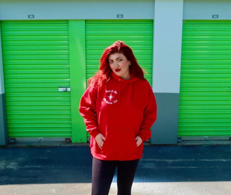 May include: A red hooded sweatshirt with a white star and the text "Walk by Faith, Not by Sight" embroidered on the front.