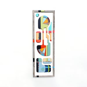 Puede incluir: Arte de pared geom&eacute;trico abstracto con un marco de madera. La obra de arte presenta una variedad de formas y colores, incluyendo azul, verde, rojo, amarillo y naranja.