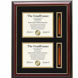 May include: A rectangular dark wood diploma frame with a black mat featuring two horizontal document openings and two vertical tassel slots. The frame displays two identical documents titled The GradFramer with gold accents and orange tassels.