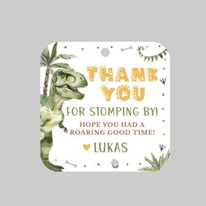 May include: Square tag with a watercolor illustration of a green Tyrannosaurus Rex and a palm tree. The tag reads "THANK YOU FOR STOMPING BY! HOPE YOU HAD A ROARING GOOD TIME!" and includes the name "LUKAS".