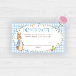 May include: A baby shower diaper raffle card with a blue gingham background and a watercolor illustration of Peter Rabbit. The card reads "DIAPER RAFFLE" and includes space for a name. A carrot and a pink flower are also featured.