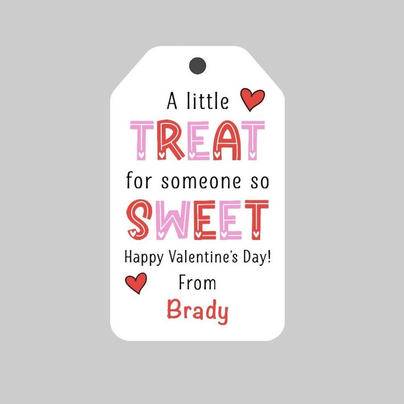 May include: A white gift tag with red and pink hearts and the text "A little TREAT for someone so SWEET Happy Valentine's Day! From Brady".
