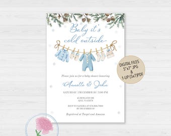 May include: A baby shower invitation with a winter theme. The invitation features a clothesline with baby clothes, pine branches, and the text "Baby it's cold outside." The invitation is for Annette & John.