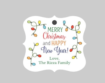 May include: White gift tag with a festive design featuring colorful string lights and the text "Merry Christmas and Happy New Year! Love, The Rizza Family".