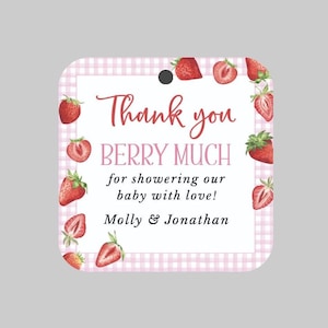 May include: Pink and white gingham patterned thank you tag with red strawberries and the text "Thank you BERRY MUCH for showering our baby with love! Molly & Jonathan"