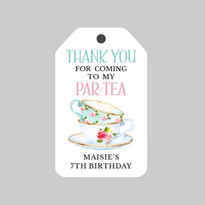 May include: White thank you tag with a stack of three teacups with floral designs. The tag says "Thank you for coming to my Par-Tea Maisie's 7th Birthday".