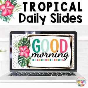 May include: A laptop computer displaying a tropical themed "Good Morning" slide with a pink hibiscus flower and green leaves. The slide has a black border and colourful text. The laptop is on a white surface.