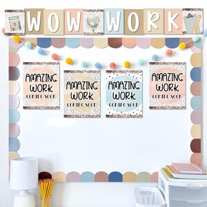 May include: A classroom bulletin board with the words "WOW WORK" in individual letter blocks. Below are four posters that read "AMAZING WORK COMING SOON". The board is decorated with a pom-pom garland and scalloped borders in pastel colors.