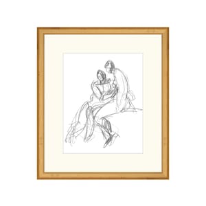 May include: A black and white pencil sketch of two people sitting together. The sketch is framed in a gold frame.