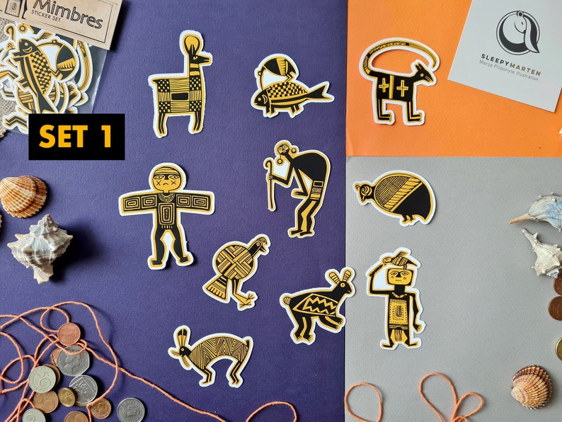May include: Set of 12 black and gold Mimbres style stickers featuring various animal and human figures. The stickers are arranged on a purple, orange, and gray background. The text "SET 1" is visible in the top left corner.