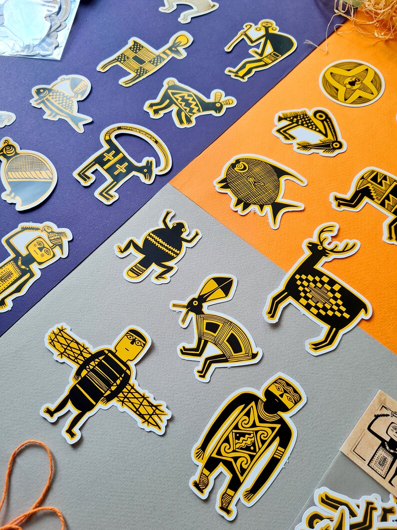 May include: A set of yellow and black patterned stickers featuring various animal and human figures. The stickers are on a purple and orange background.