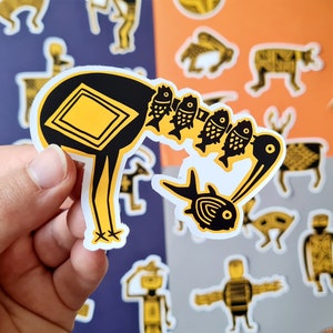 May include: A black and yellow sticker of a bird carrying a string of fish. The bird has a square shape on its back and a long neck. The fish are yellow and black with a white outline.